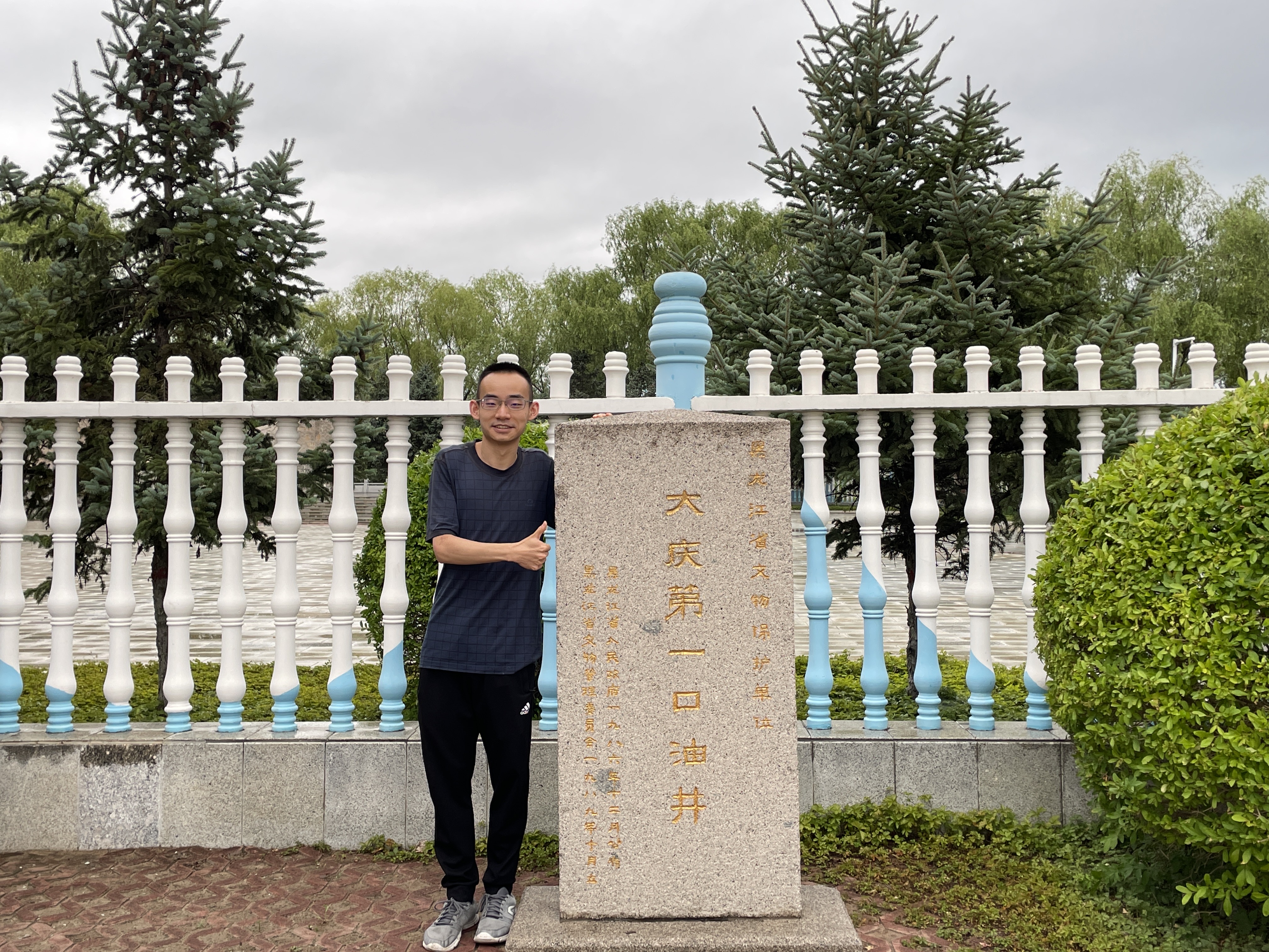I stand next to the monument to the "First Oil Well in Daqing City, Heilongjiang Province". Photo taken on July 13, 2022.